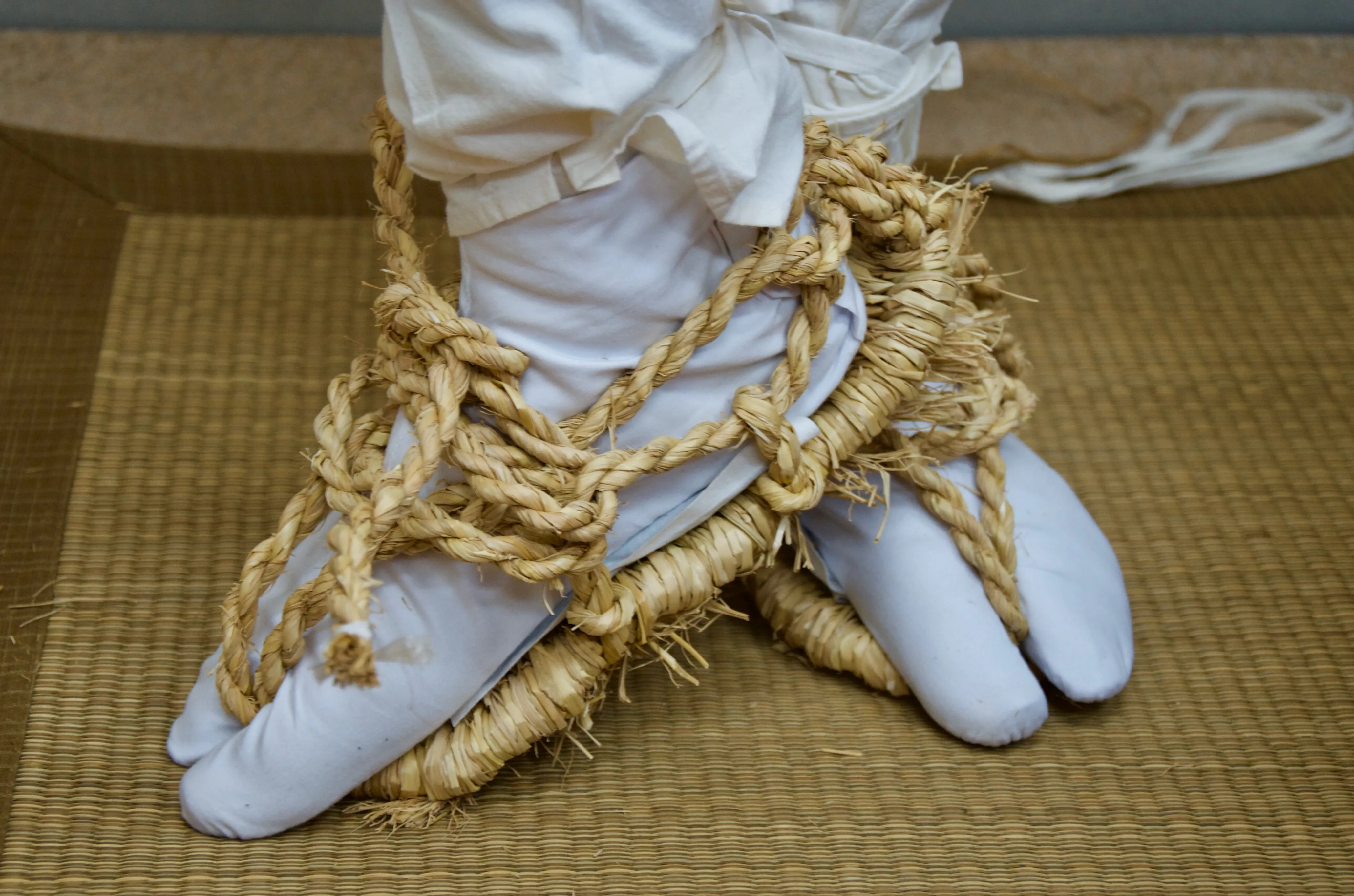 A pair of traditional straw waraji shoes.